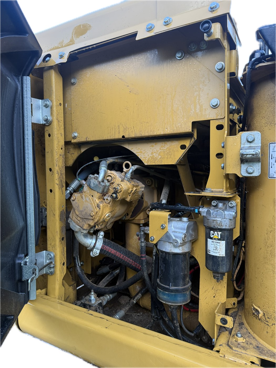 CAT excavator engine bay — before wash